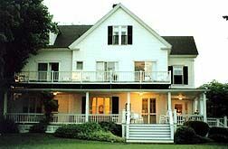 home with lighted porch in a small town on the coast of maine