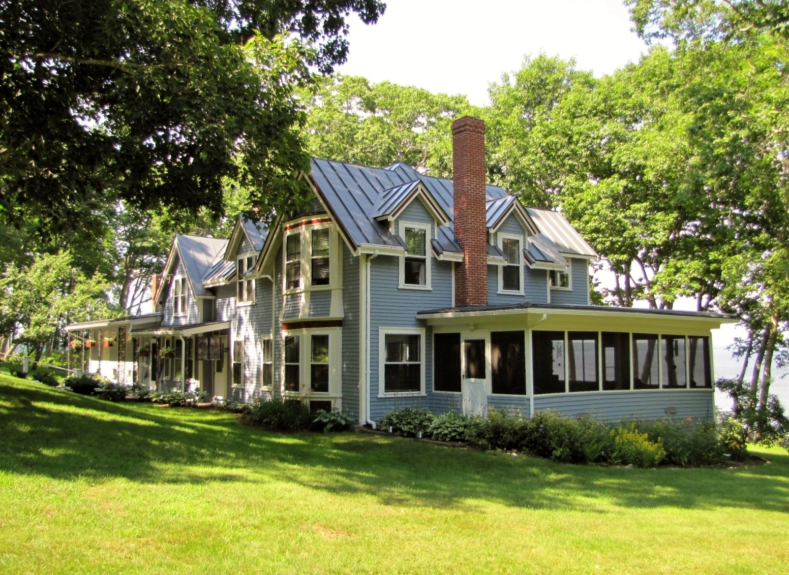 Oceanfront Victorian with 3 wood-burning fireplaces, 
		hardwood wood floors, a family/media room with its own galley kitchen and a handsome carriage house