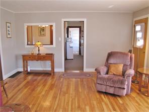 Light, bright living room with recently refinished hardwood floors