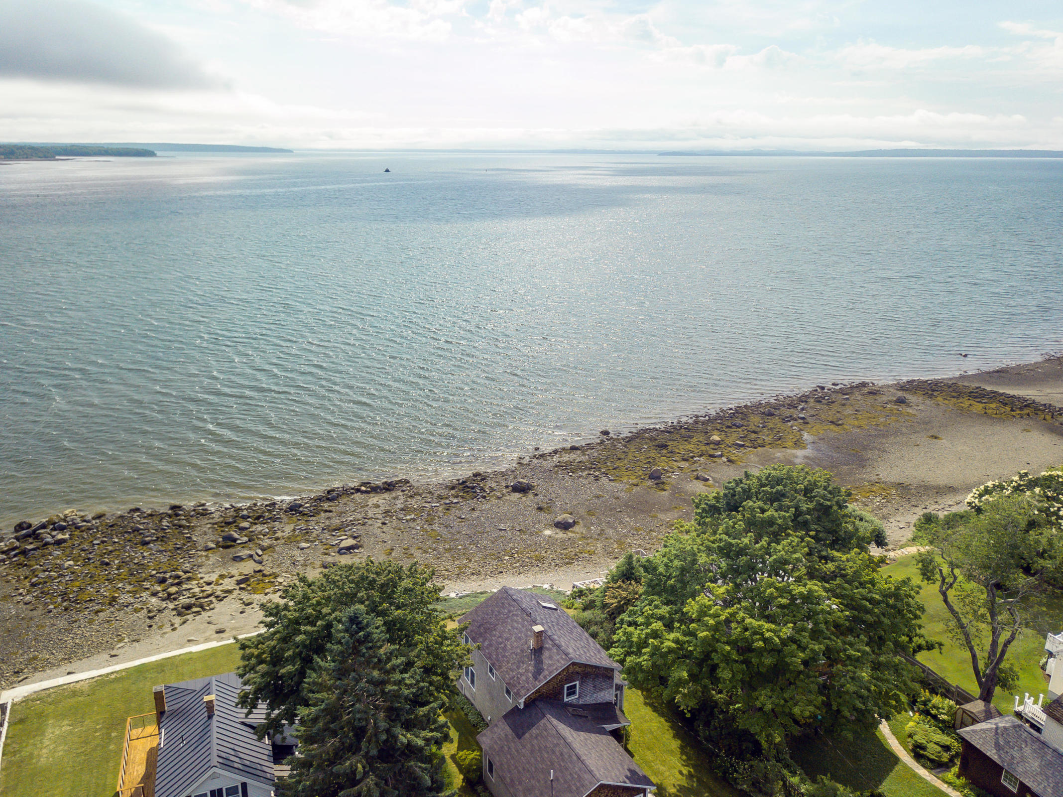 charming in-town, oceanfront home in one of Belfast's most desirable neighborhoods is sited at the waters edge and 
offers unparalleled views of Penobscot Bay from nearly every room