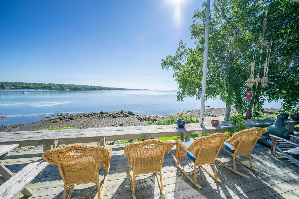 Maine home for sale sited at the water's edge on a beautifully landscaped lot, this turnkey, two-bedroom, 2-bath home